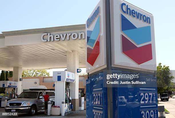 Chevron customer looks under the hood of his car at a Chevron service station July 9, 2009 in San Rafael, California. Chevron will report quarterly...