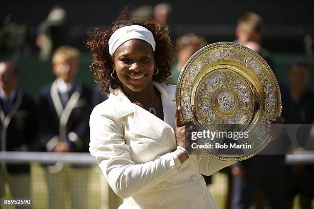 Serena Williams victorious with Rosewater Dish trophy after match vs USA Venus Williams during Women's Finals at All England Club. London, England...