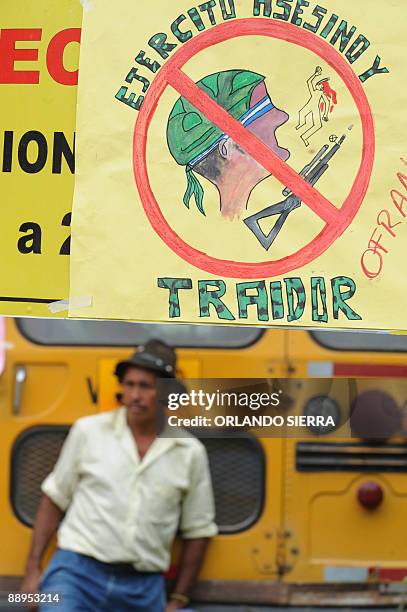 Peasant looks at supporters of deposed Honduran President Manuel Zelaya blocking the Inter American road leading to El Salvador in protest for the...