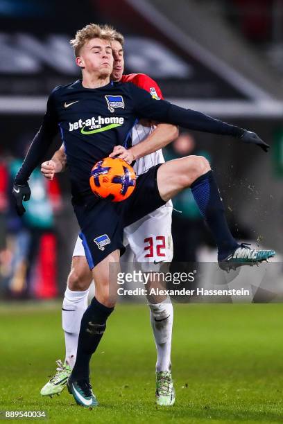 Raphael Framberger of Augsburg and Maximilian Mittelstadt of Hertha Berlin battle for the ball during the Bundesliga match between FC Augsburg and...