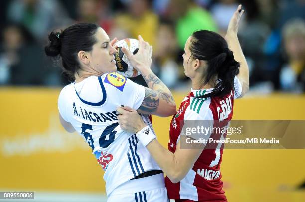 Alexandra Lacrabere of France and Anita Goerbicz of Hungary vie for the ball during IHF Women's Handball World Championship round of 16 match between...