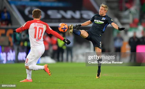 Daniel Baier of FC Augsburg and Per Skjelbred of Hertha BSC during the Bundesliga match between FC Augsburg and Hertha BSC on December 10, 2017 in...