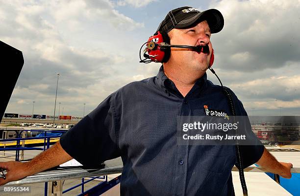 Tony Eury Jr., watches from the top of the Hendricks Motorsports hauler directing the GoDaddy Chevrolet driven by Brad Keselowski during practice for...