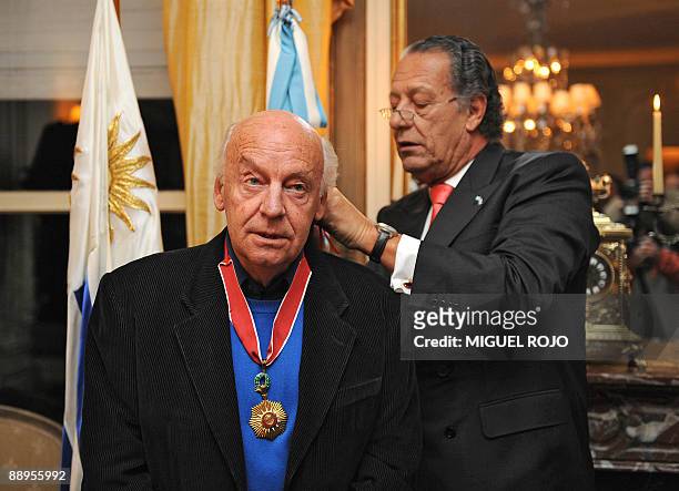 Argentine ambassador to Uruguay, Patino Mayer , decorates Uruguayan author, Eduardo Galeano, with the "Order of May with Merit in the grade of...