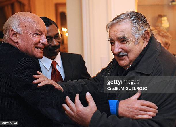 Uruguayan author, Eduardo Galeano , greets Uruguayan presidential candidate for the Frente Amplio coalition, Jose Mujica , after Galeano was...