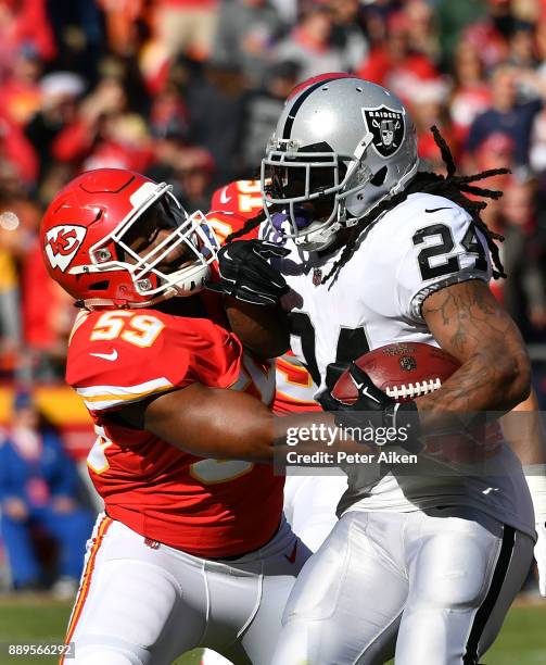 Running back Marshawn Lynch of the Oakland Raiders carries the ball as inside linebacker Reggie Ragland of the Kansas City Chiefs defends during the...