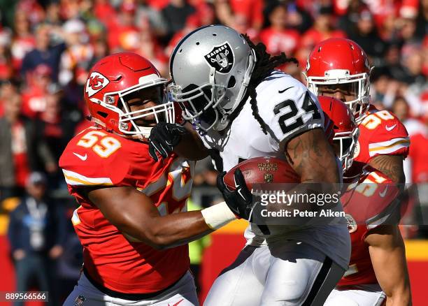 Running back Marshawn Lynch of the Oakland Raiders carries the ball as inside linebacker Reggie Ragland of the Kansas City Chiefs defends during the...
