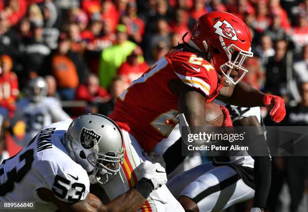 Running back Kareem Hunt of the Kansas City Chiefs carries the ball as middle linebacker NaVorro Bowman of the Oakland Raiders defends during the...