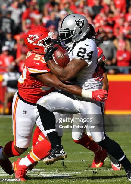 Running back Marshawn Lynch of the Oakland Raiders carries the ball as inside linebacker Reggie Ragland of the Kansas City Chiefs defends during the...