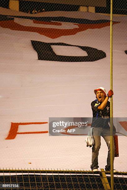 An Ecuador's Liga de Quito fan cheers for his team before the second leg 2009 Recopa Sudamericana final football match against Brazil's Internacional...