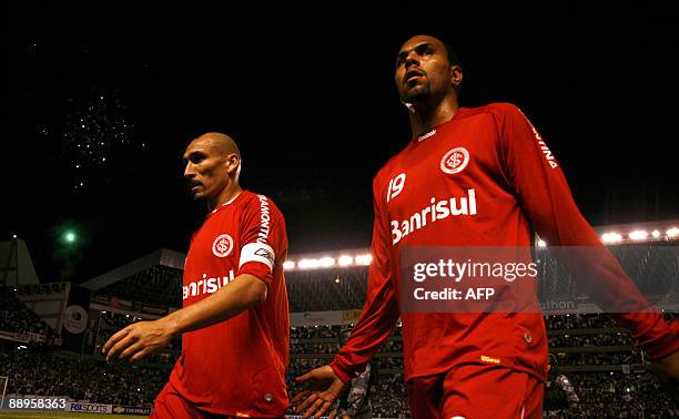 Brazil's Internacional Alecsandro and PAblo Guinazu leave the field in dejection after losing against Ecuador's Liga de Quito the second leg football...