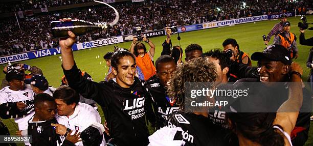 Ecuador's Liga de Quito player Norberto Araujo and his teammates celebrate their victory against Brazil's Internacional after the second leg football...