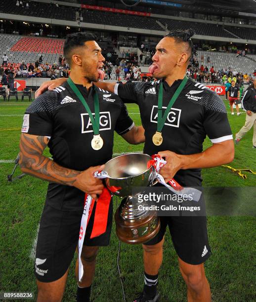 Regan Ware of New Zealand and Teddy Stanaway of New Zealand pose with trophy after the 2017 HSBC Cape Town Sevens Cup Final match between New Zealand...
