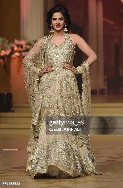 Model presents a creation by designer Umsha by Uzma Babar on the last day of the Pantene Hum Bridal Couture Week in Lahore on December 10, 2017. /...