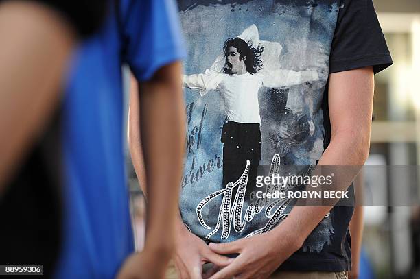 Michael Jackson fans wait in line to take part in a moonwalk contest, at a one-day tribute to the "King of Pop" which included outdoor screenings of...