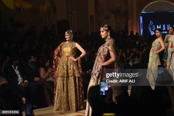 Models present creations by designer Umsha by Uzma Babar on the last day of the Pantene Hum Bridal Couture Week in Lahore on December 10, 2017. / AFP...