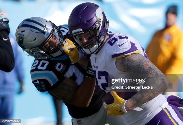 Kyle Rudolph of the Minnesota Vikings runs the ball against Kurt Coleman of the Carolina Panthers in the second quarter during their game at Bank of...