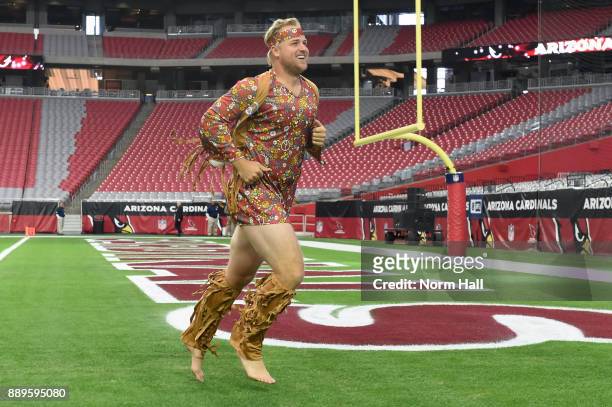 Matt Barkley of the Arizona Cardinals runs on the field in a costume prior to the NFL game between the Tennessee Titans and Arizona Cardinals at...