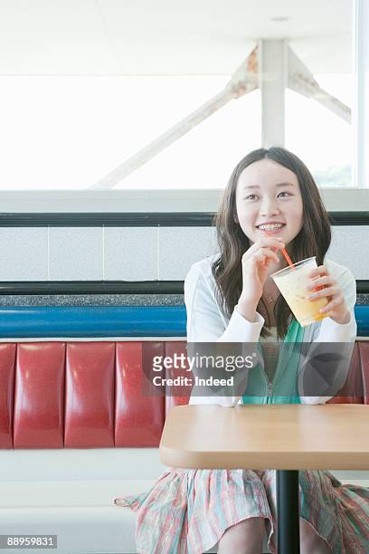 teenage girl drinking juice - teenagers only stock pictures, royalty-free photos & images