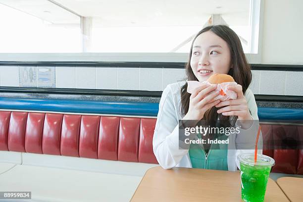 teenage girl having burger and soda - teenagers only stock pictures, royalty-free photos & images