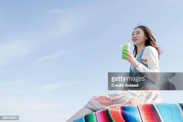 girl having soda on table - alleen tieners stockfoto's en -beelden