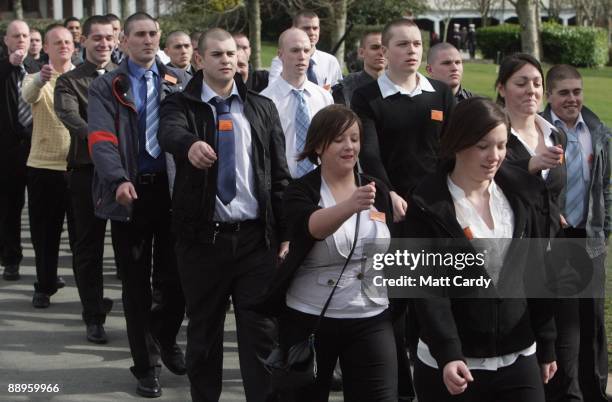 Royal Navy recruits march to the gymnasium after arriving at the training establishment HMS Raleigh on the first day of their initial nine-week basic...