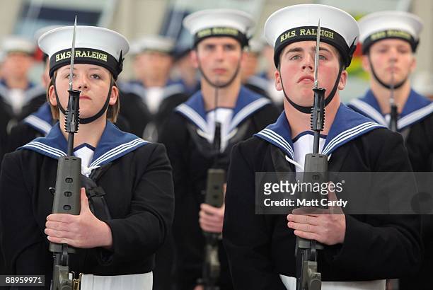Royal Navy recruits Nicola Morris and Daniel Wright stand to attention during their passing out parade at the training establishment HMS Raleigh on...