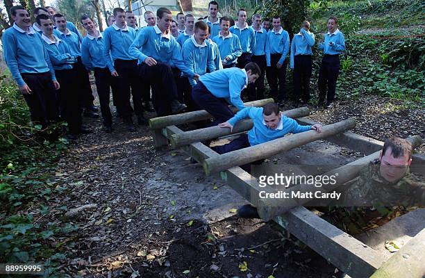 Royal Navy recruits train on the obstacle course at the Piers Cellars training centre as they take part in team-building exercises close to the...