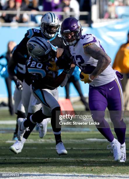 Kyle Rudolph of the Minnesota Vikings runs the ball against Kurt Coleman of the Carolina Panthers in the second quarter during their game at Bank of...