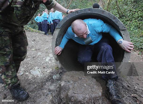 Royal Navy recruits train on the obstacle course at the Piers Cellars training centre as they take part in team-building exercises close to the...