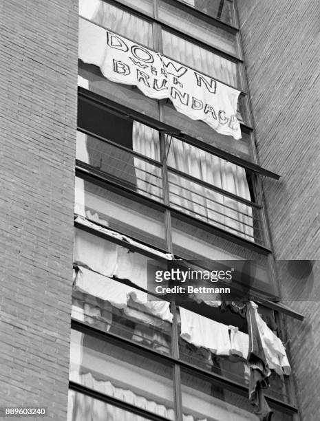 Homemade sign, reading "Down With Brundage," hangs from a window in the American dormitory at Olympic Village October 18th after the U.S. Olympic...