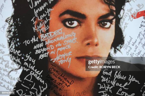 Poster of Michael Jackson is covered with messages from fans at a one-day tribute to the "King of Pop" which included outdoor screenings of "The Wiz"...