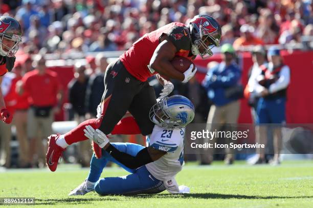 Tampa Bay Buccaneers running back Doug Martin is tackled by Detroit Lions cornerback Darius Slay in the first quarter of the NFL game between the...