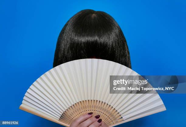 woman behind a fan - éventail photos et images de collection