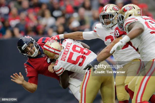 Tom Savage of the Houston Texans is hit by Elvis Dumervil of the San Francisco 49ers in the second quarter at NRG Stadium on December 10, 2017 in...