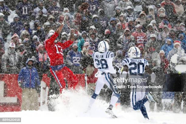 Kelvin Benjamin of the Buffalo Bills attempts to catch a ball as Chris Milton of the Indianapolis Colts and Darius Butler of the Indianapolis Colts...