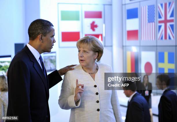 German Chancellor Angela Merkel and US President Barack Obama chat ahead of a meeting with the leaders of the Group of Eight , Brazil, China, India,...