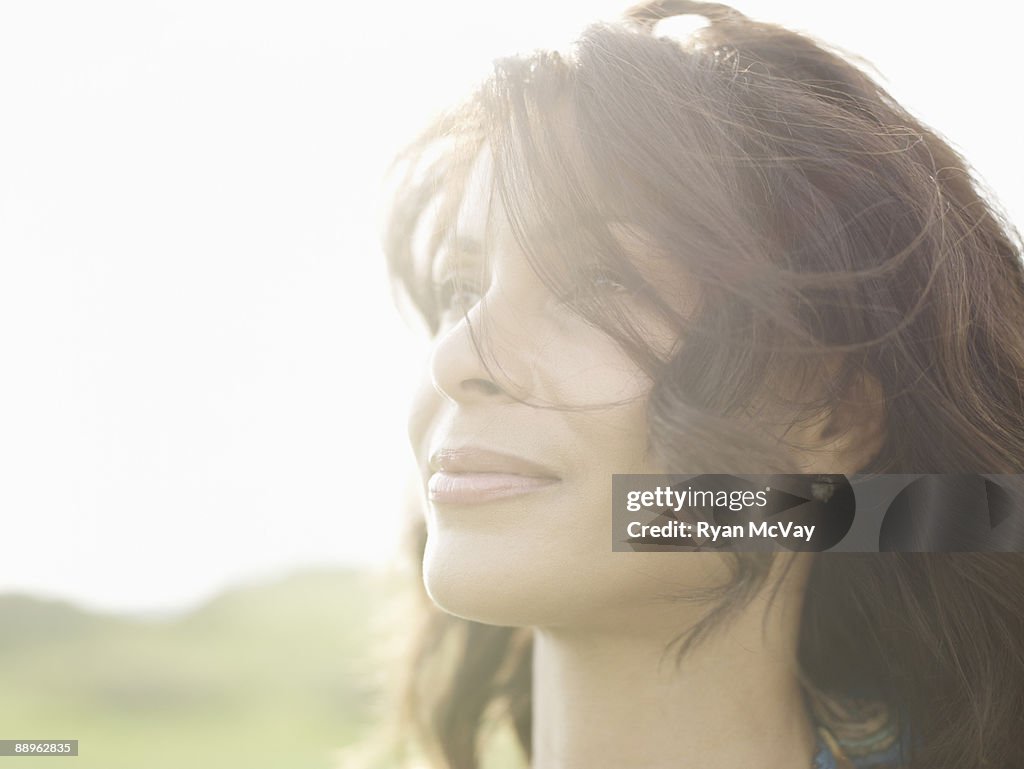 Mature woman with hair blowing