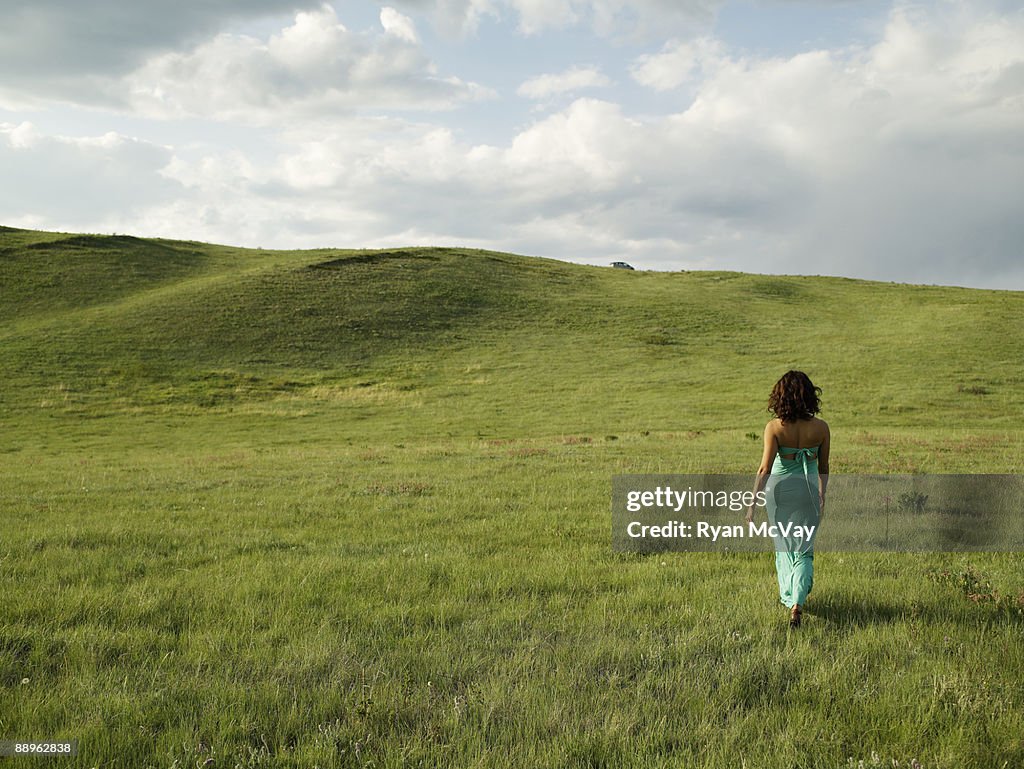 Mature woman walking in grassy field