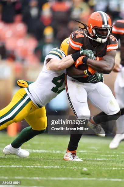 Isaiah Crowell of the Cleveland Browns is tackled by Jake Ryan of the Green Bay Packers in the second quarter at FirstEnergy Stadium on December 10,...
