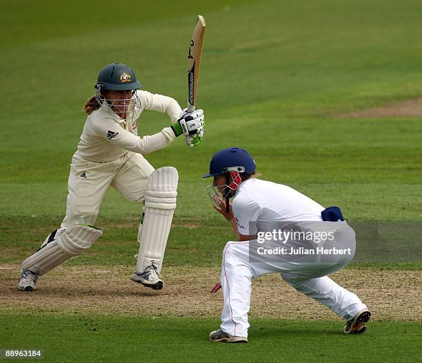 Jodie Fields of Australia hits out past Beth Morgan during Day One of The 1st Test between England Women and Australia Women at New Road on July 10,...