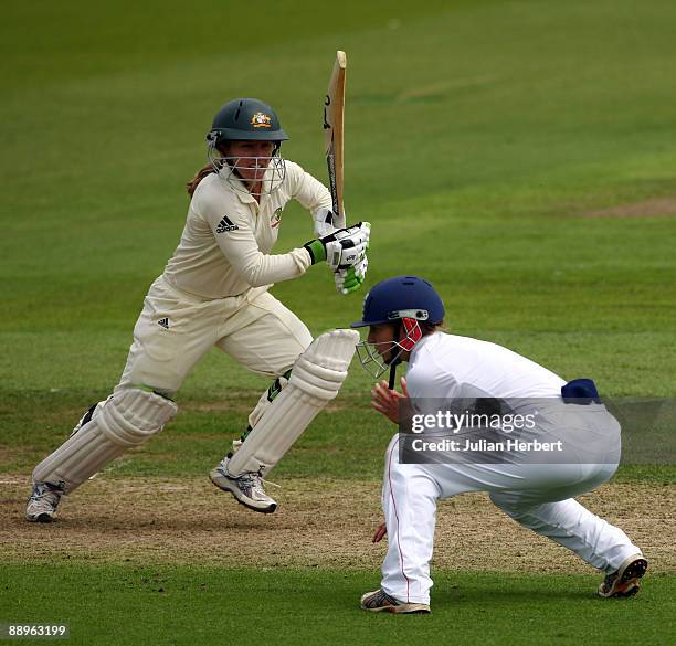 Jodie Fields of Australia hits out past Beth Morgan during Day One of The 1st Test between England Women and Australia Women at New Road on July 10,...
