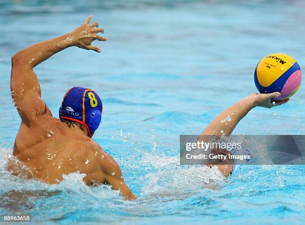 Zivko Gocic of Serbia drives the ball against Albert Espanol of Spain in the men's Waterpolo 1st and 2nd place game at the XVI Mediterranean Games...