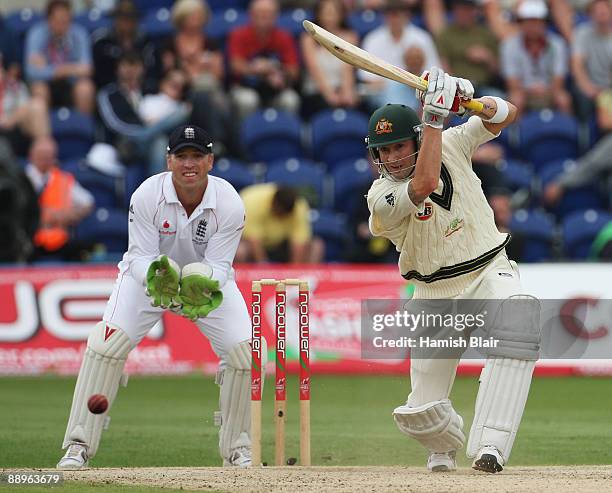 Michael Clarke of Australia hits out watched by Matt Prior of England during day three of the npower 1st Ashes Test Match between England and...