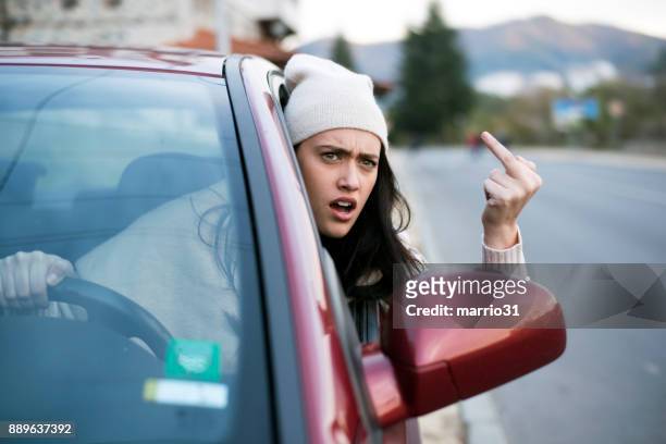 angry female driver showing the finger - road rage stock pictures, royalty-free photos & images