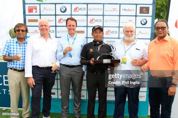 Thaworn Wiratchant of Thailand poses with officials after the final round of the MCB Tour Championship played over the Legend Course at Constance...