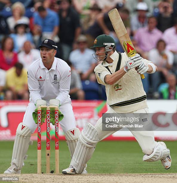 Michael Clarke of Australia hits out watched by Matt Prior of England during day three of the npower 1st Ashes Test Match between England and...