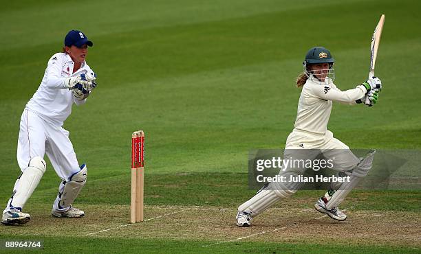 Sarah Taylor watches Jodie Fields of Australia hits out past Beth Morgan during Day One of The 1st Test between England Women and Austarlia Women at...