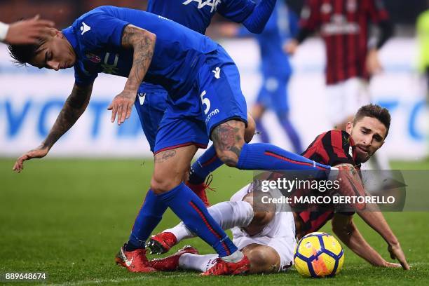 Milan's forward Fabio Borini from Italy fights for the ball with Bologna's defender Erick Pulgar from Chile during the Italian Serie A football match...