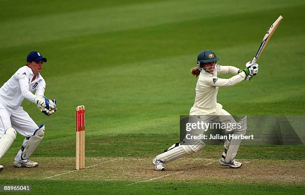 Sarah Taylor of England watches Jodie Fields of Australia hits out past Beth Morgan during Day One of The 1st Test between England Women and...